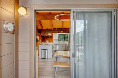 a sliding glass door leading to a kitchen with a table at Bright 3BR Condo Near Northstar in Truckee