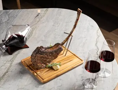 a plate of food on a table with two glasses of wine at Chicken Ranch Casino Resort in Jamestown