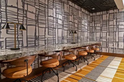 a row of stools in a room with black and white wallpaper at Chicken Ranch Casino Resort in Jamestown