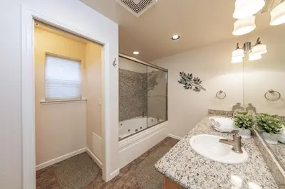 a bathroom with a sink and a shower at Cabin at the Creek Family Fun Starts Here! in Shaver Lake