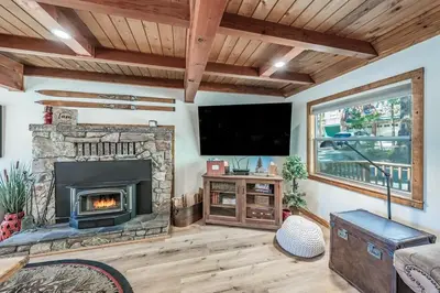 a living room with a fireplace and a flat screen tv at Buckeye Bear's Den-AC-Walking Distance to town in Shaver Lake