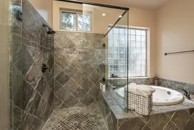 a bathroom with a shower and a tub and a sink at Leopard Lily Lodge Luxe Stays 2 Suites AC in Shaver Lake