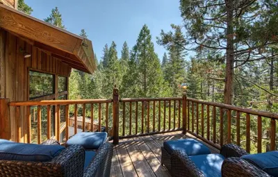 a deck with couches and chairs on a cabin at Waterfall Lodge Yellowstone Vibes AC Space in Shaver Lake