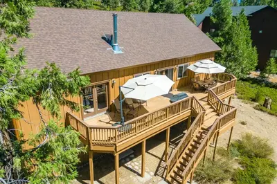 an overhead view of a house with a deck with umbrellas at The Restful Rose Fireside Vibes AC Comfort in Shaver Lake