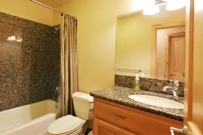 a bathroom with a sink and a toilet and a bath tub at The Restful Rose Fireside Vibes AC Comfort in Shaver Lake