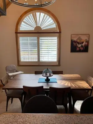 a room with a large wooden table and a large window at The Knotty Sparrow Prime Spot Smores Nights in Shaver Lake