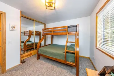 a bedroom with bunk beds in a house at The Knotty Sparrow Prime Spot Smores Nights in Shaver Lake