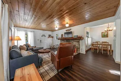 a living room with a couch and a table at The Cedar House Prime Spot Kayaks & Cool AC in Shaver Lake