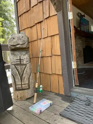 a statue of a frog with a mop on a porch at The Cedar House Prime Spot Kayaks & Cool AC in Shaver Lake