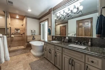 a bathroom with two sinks and a toilet in it at Lux Western Cabin Pool Table Ping Pong Vibes in Shaver Lake