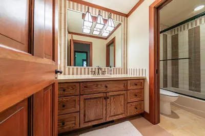 a bathroom with a sink and a mirror at Chambers Lakeside Escape w Lake Views & HOA Access! in Homewood