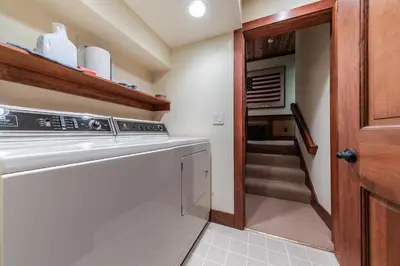 a kitchen with a dishwasher next to a staircase at Chambers Lakeside Escape w Lake Views & HOA Access! in Homewood