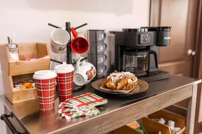 a counter top with a coffee maker and a plate of food at The Chalet at Shaver Lake We Have it ALL! in Shaver Lake