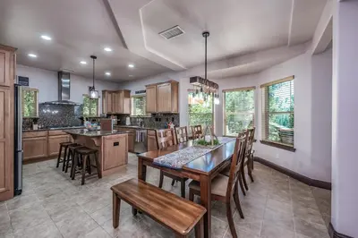 a kitchen with a table and chairs in a room at The Chalet at Shaver Lake We Have it ALL! in Shaver Lake