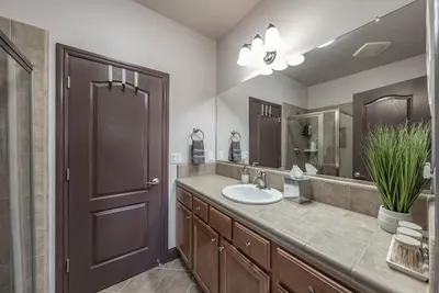 a bathroom with a sink and a large mirror at The Chalet at Shaver Lake We Have it ALL! in Shaver Lake
