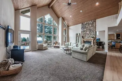 a large living room with a couch and a fireplace at Sunset Mountain Hot Tub, Fire Table, Epic Views in Shaver Lake