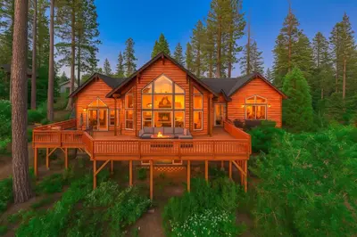 a large wooden house with a large deck at Sunset Mountain Hot Tub, Fire Table, Epic Views in Shaver Lake