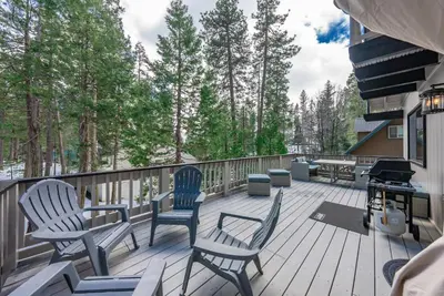 two chairs and a grill on a deck with trees at Ridgeview Retreat Location Meets Comfort AC! in Shaver Lake