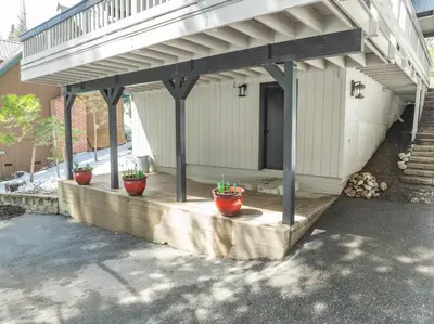 a porch with three potted plants on it at Ridgeview Retreat Location Meets Comfort AC! in Shaver Lake