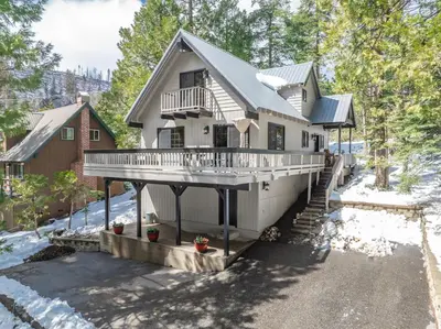 a large house with a porch and a balcony at Ridgeview Retreat Location Meets Comfort AC! in Shaver Lake