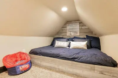 a bedroom with a bed and a suitcase at Hibernation Station Walkable, Warm Well-Loved in Shaver Lake