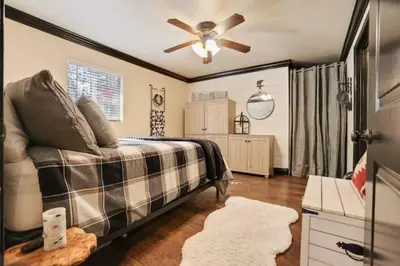 a bedroom with a bed and a ceiling fan at Hibernation Station Walkable, Warm Well-Loved in Shaver Lake