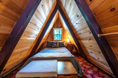 a room with two beds in a attic at A-Frame Escape Unique stay w comfort & style in Shaver Lake