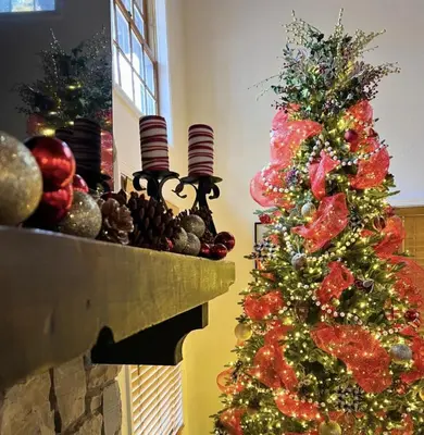 a christmas tree sitting on top of a fireplace at Creekside Cabin - Pup-Friendly with AC in Shaver Lake