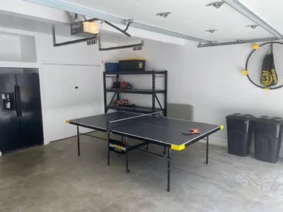 a ping pong table in a room with a racket at Creekside Cabin - Pup-Friendly with AC in Shaver Lake