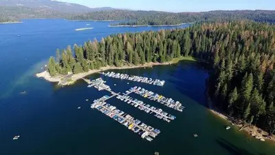 an aerial view of a lake with a bunch of boats at Creekside Cabin - Pup-Friendly with AC in Shaver Lake