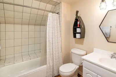 a bathroom with a toilet and a tub and a sink at The Elderberry Retreat - It's a Dream Location! in Shaver Lake