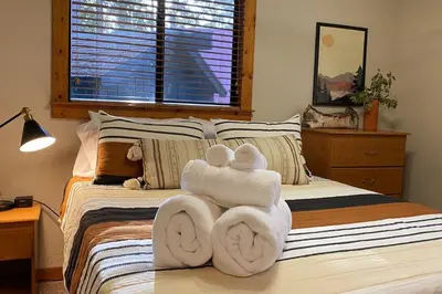 a bedroom with a bed with towels on it at The Elderberry Retreat - It's a Dream Location! in Shaver Lake