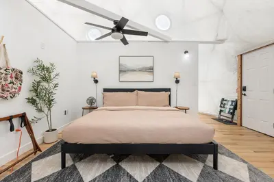 a bedroom with a bed and a ceiling fan at Dome Sweet Dome | Shaver Lake in Shaver Lake