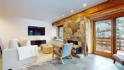 a living room with a stone fireplace and a couch at Lakeview Villas #09 condo in Mammoth Lakes
