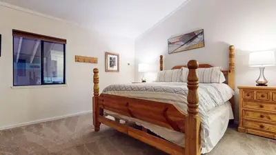 a bedroom with a bed and a dresser and a window at Summit #48 condo in Mammoth Lakes