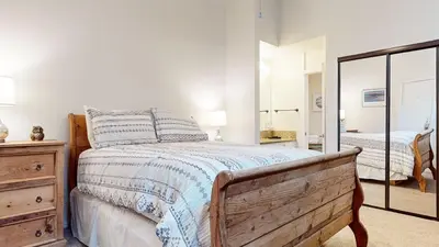 a bedroom with a bed and a dresser and a mirror at Summit #48 condo in Mammoth Lakes