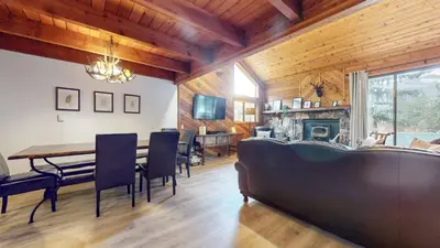a dining room with a table and chairs and a fireplace at Snowflower #75 condo in Mammoth Lakes