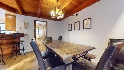 a dining room with a wooden table and chairs at Snowflower #75 condo in Mammoth Lakes