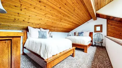a bedroom with two beds and a wooden ceiling at Snowflower #75 condo in Mammoth Lakes