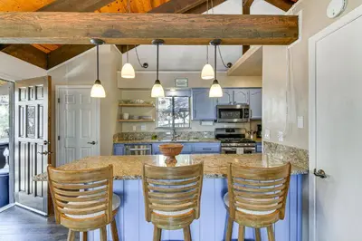a kitchen with a island with four bar stools at Near Skiing and Beach Access South Lake Tahoe Cabin in South Lake Tahoe