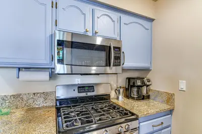 a kitchen with a stove and a microwave at Near Skiing and Beach Access South Lake Tahoe Cabin in South Lake Tahoe