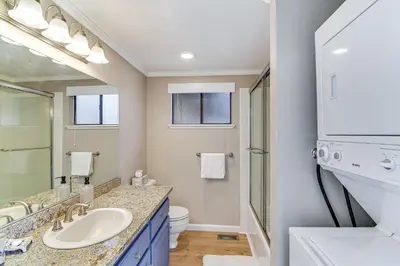 a bathroom with a sink and a toilet and a mirror at Near Skiing and Beach Access South Lake Tahoe Cabin in South Lake Tahoe