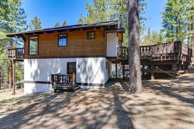 a log cabin with a porch and a tree at Near Skiing and Beach Access South Lake Tahoe Cabin in South Lake Tahoe