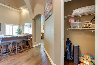 a kitchen with a bar and stools in a room at Clovis Retreat with Patio and Yard about 3 Mi to Old Town! in Clovis