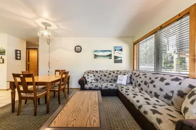 a living room with a couch and a table at Spacious 1br Condo w/Partial Lake View #117 at Donner Lake Village in Truckee