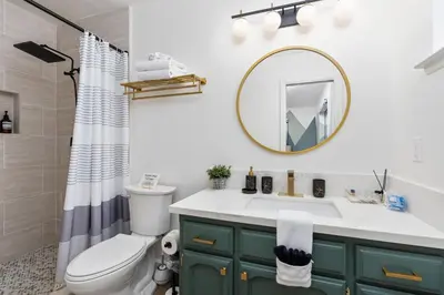 a bathroom with a sink and a toilet and a mirror at Secluded Mtn Top Family Haven with Spa, Views & Arcade in Oakhurst