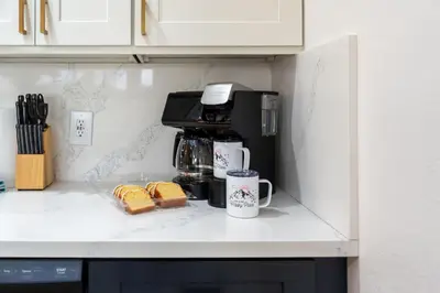 a cupboard with a coffeemaker and a coffee maker at Secluded Mtn Top Family Haven with Spa, Views & Arcade in Oakhurst
