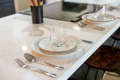 a table with two plates and a glass on it at Secluded Mtn Top Family Haven with Spa, Views & Arcade in Oakhurst