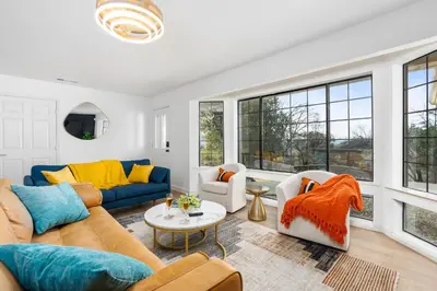 a living room with a couch and chairs and windows at Secluded Mtn Top Family Haven with Spa, Views & Arcade in Oakhurst