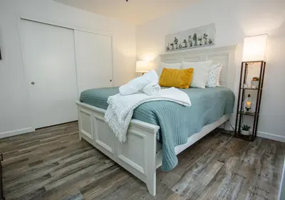 a bedroom with a bed with green and white blankets and pillows at Comfort meets Tranquility by the Sequoia Entrance in Three Rivers